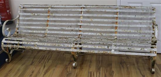 A 19th century white painted four seated slatted iron garden bench, W.212cm